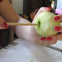 push skewer into apple